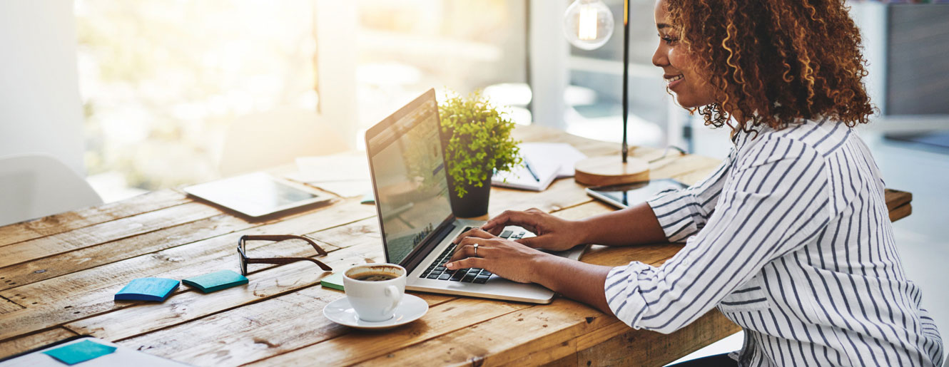 Woman typing on laptop at her desk
